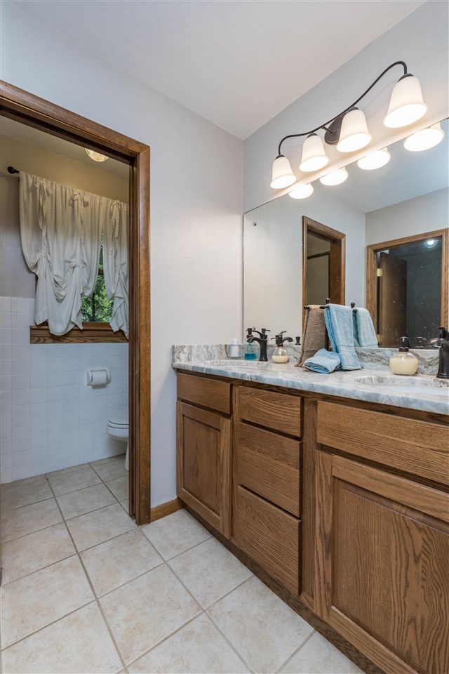 8488 Grange Hall Road Garden Prairie, IL 61038 - Photo 16 of 35 a bathroom with a granite countertop sink vanity and mirror