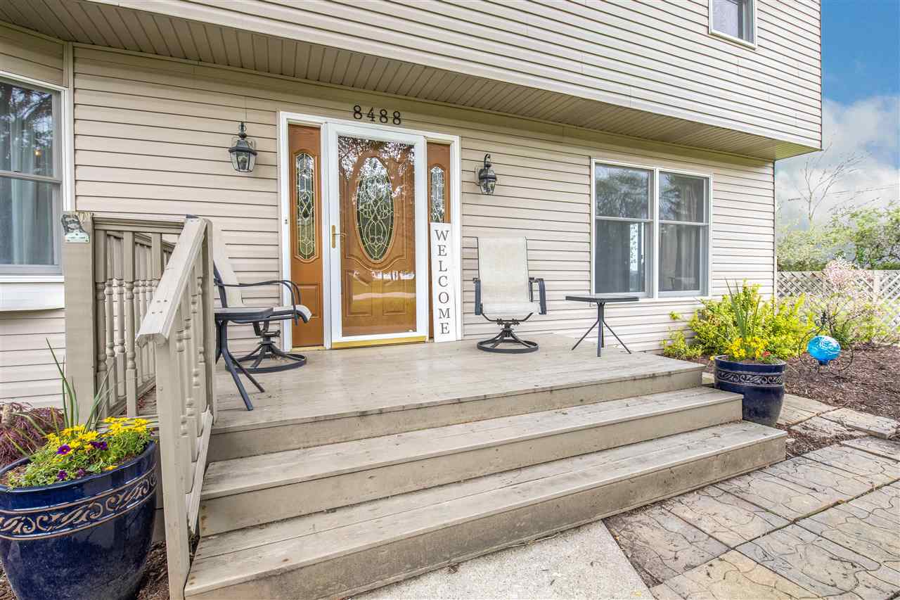 8488 Grange Hall Road Garden Prairie, IL 61038 - Photo 2 of 35 a front view of a house with a potted plant