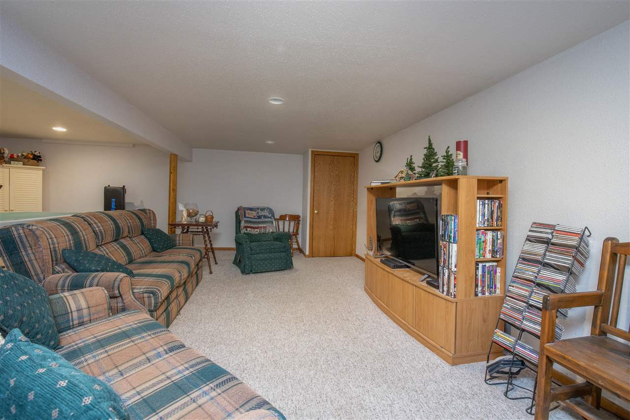 8488 Grange Hall Road Garden Prairie, IL 61038 - Photo 27 of 35 a living room with furniture and a flat screen tv