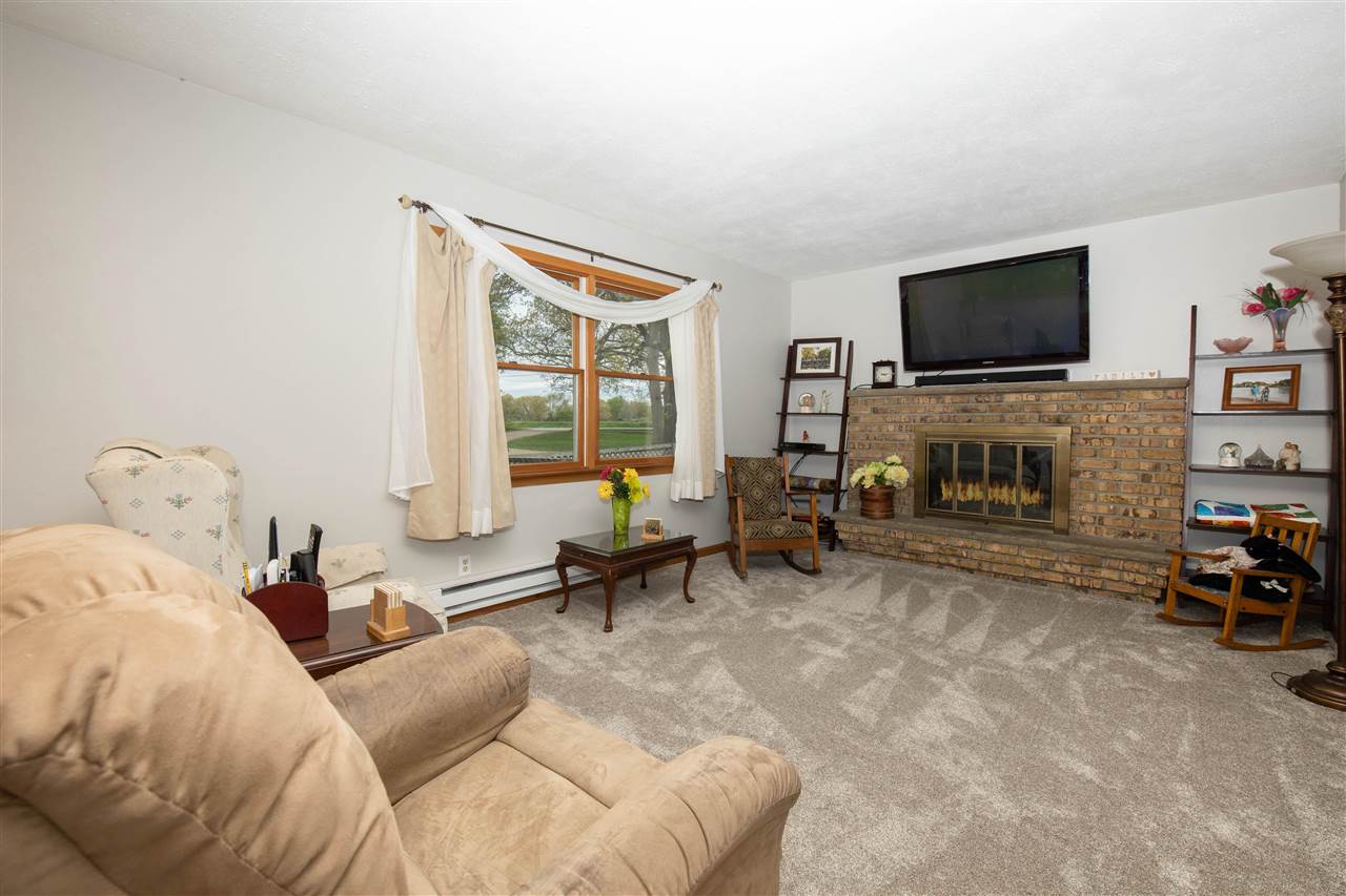 8488 Grange Hall Road Garden Prairie, IL 61038 - Photo 8 of 35 a living room with furniture and a flat screen tv