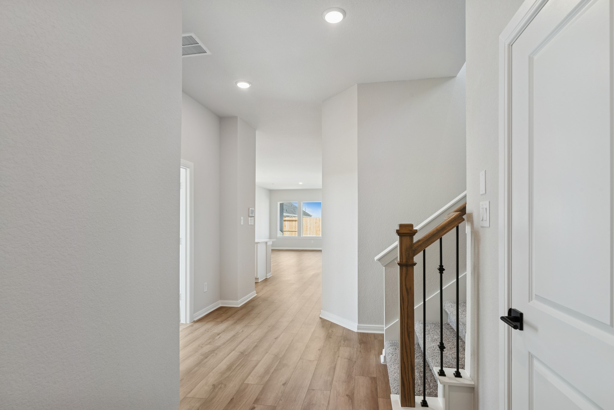 26502 Delightful Drive Hockley, TX 77447 - Photo 11 of 50 a view of a hallway with wooden floor and staircase