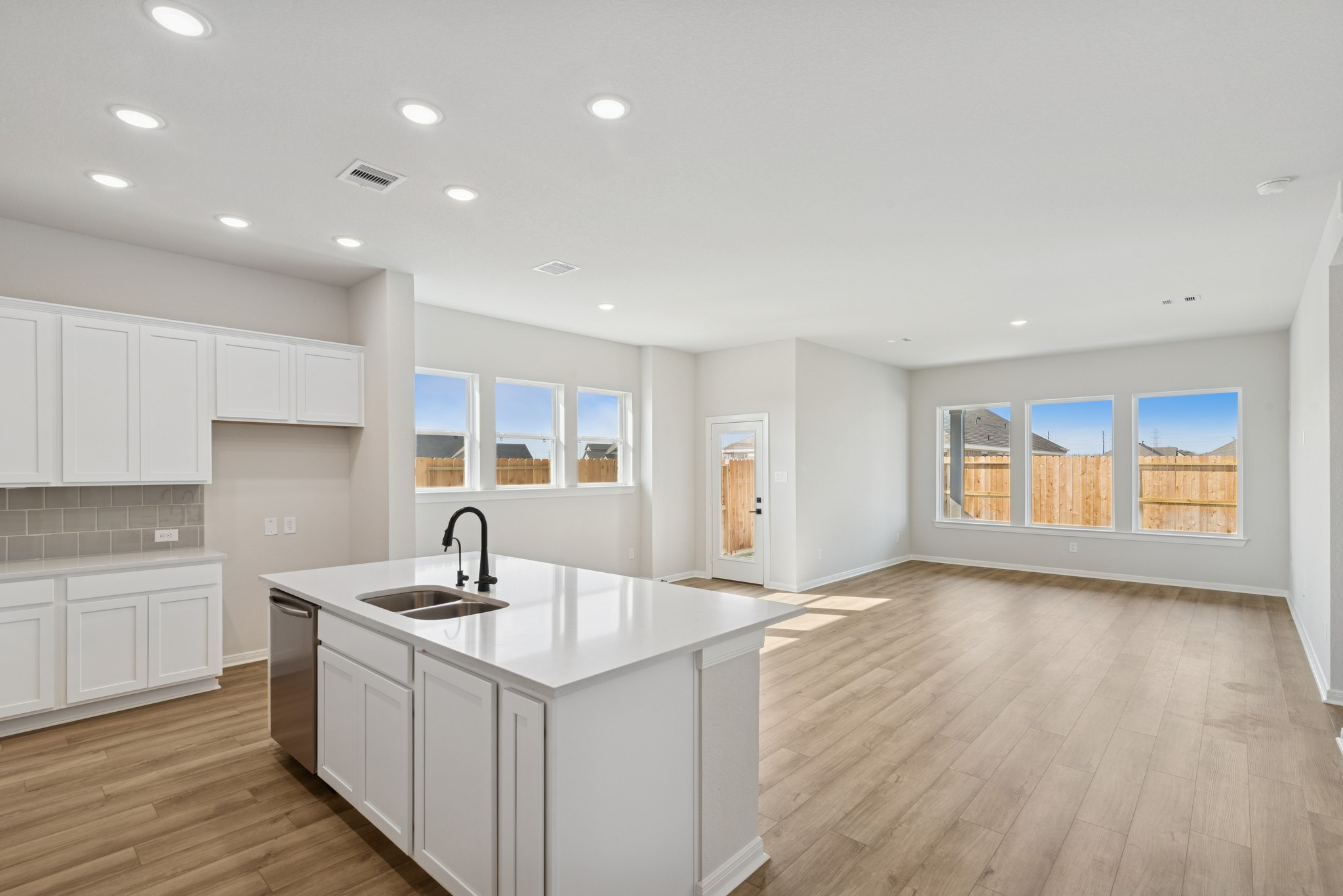 26502 Delightful Drive Hockley, TX 77447 - Photo 17 of 50 a kitchen with a sink cabinets and wooden floor