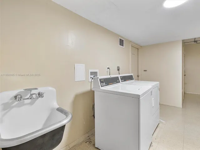 a utility room with a sink dryer and washer