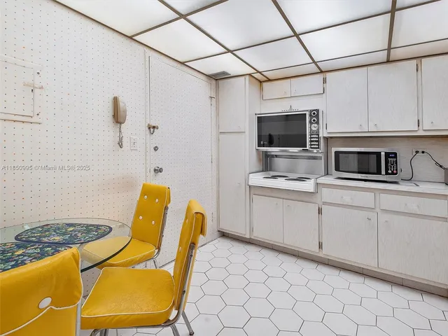a view of a kitchen with appliances and cabinets