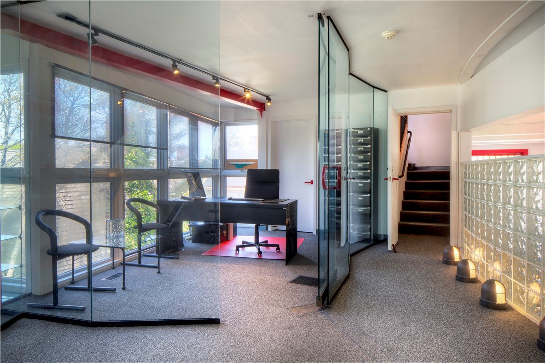 25 Mill Street Newport, RI 02840 - Photo 19 of 46 A few steps up from the second floor office space are two glass-enclosed offices and a bathroom with a shower.