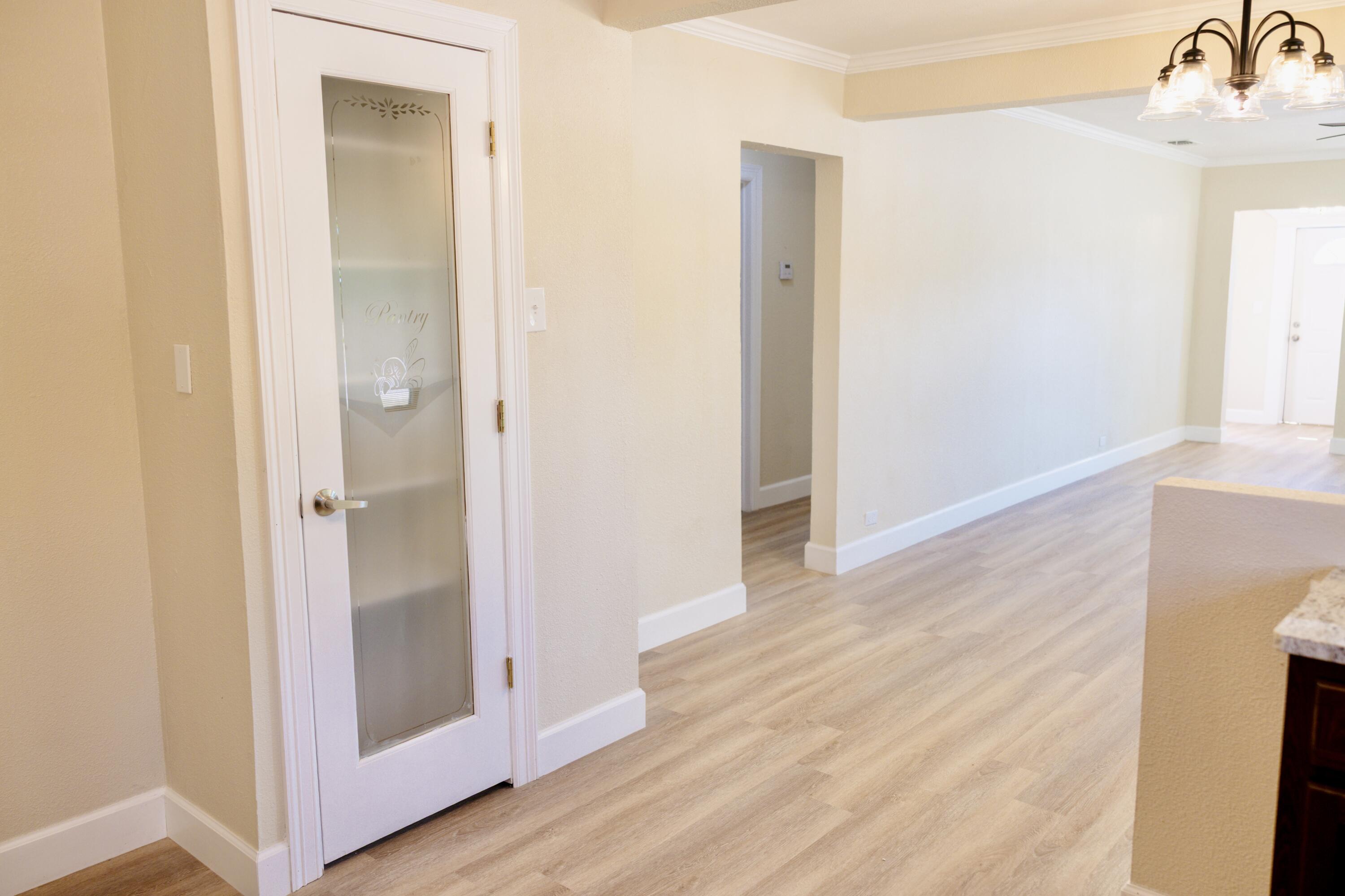 1410 West 8th Street Plainview, TX 79072 - Photo 11 of 24 a view of a hallway with wooden floor