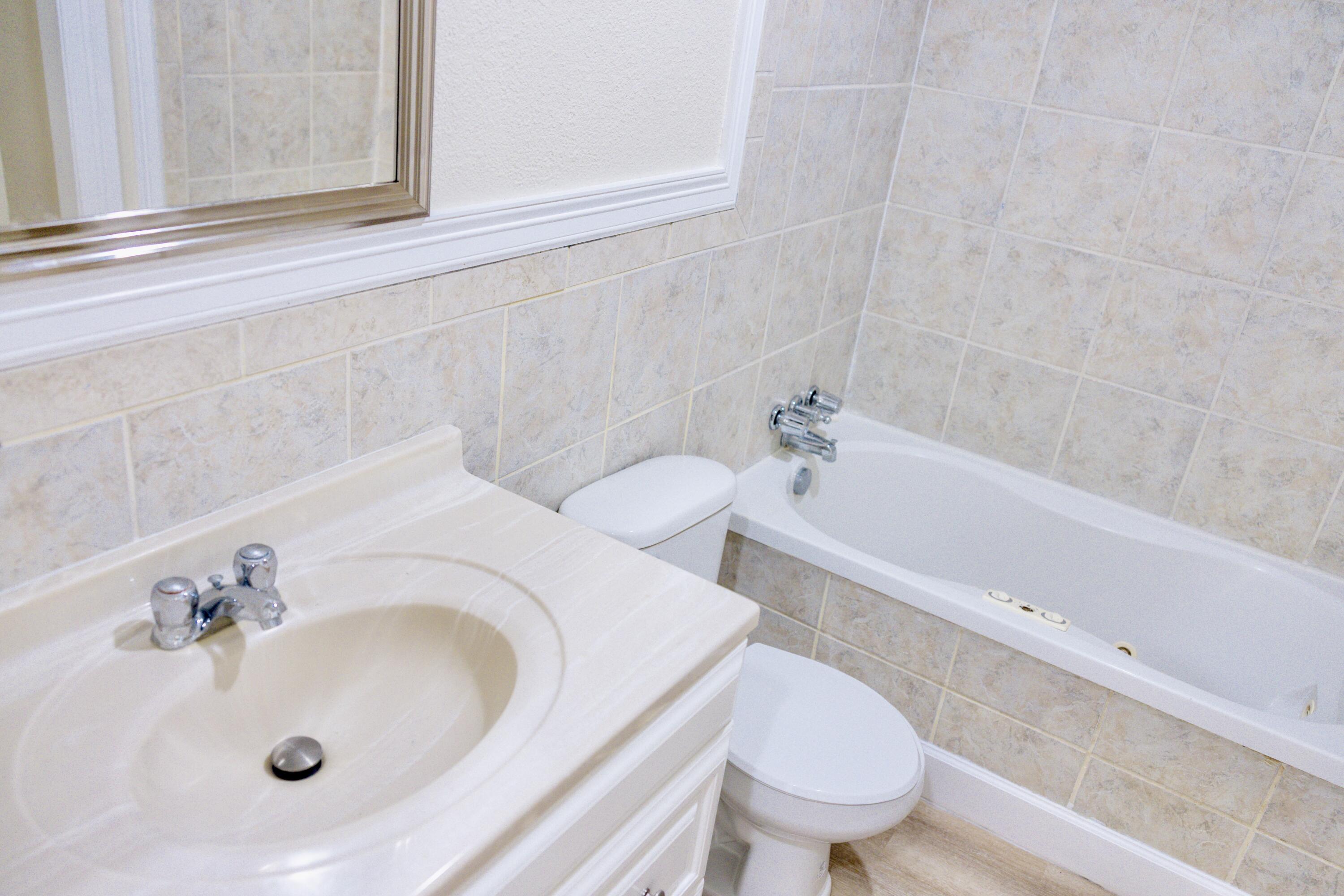 1410 West 8th Street Plainview, TX 79072 - Photo 17 of 24 a bathroom with a sink and a toilet