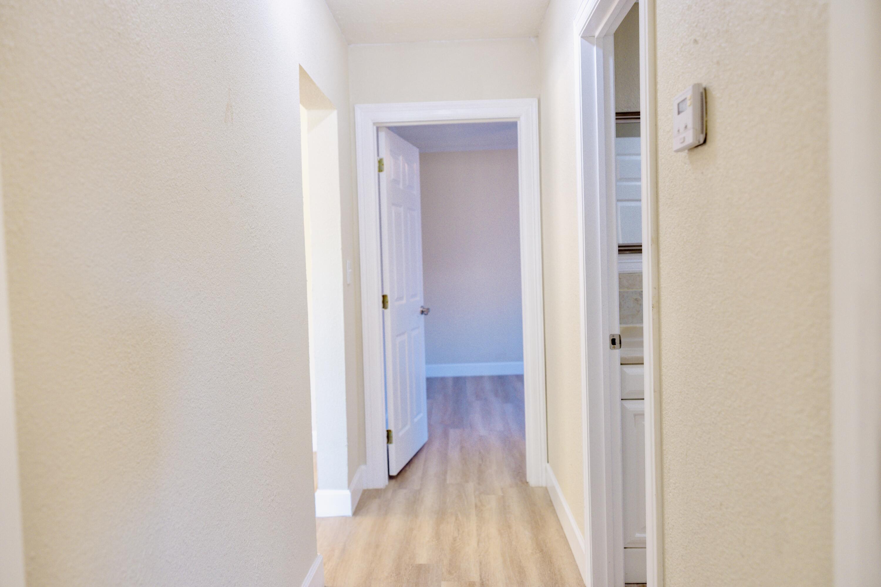 1410 West 8th Street Plainview, TX 79072 - Photo 19 of 24 a view of a hallway with wooden floor