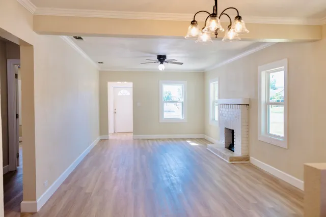 a kitchen with stainless steel appliances granite countertop a sink and a granite counter tops with wooden floors