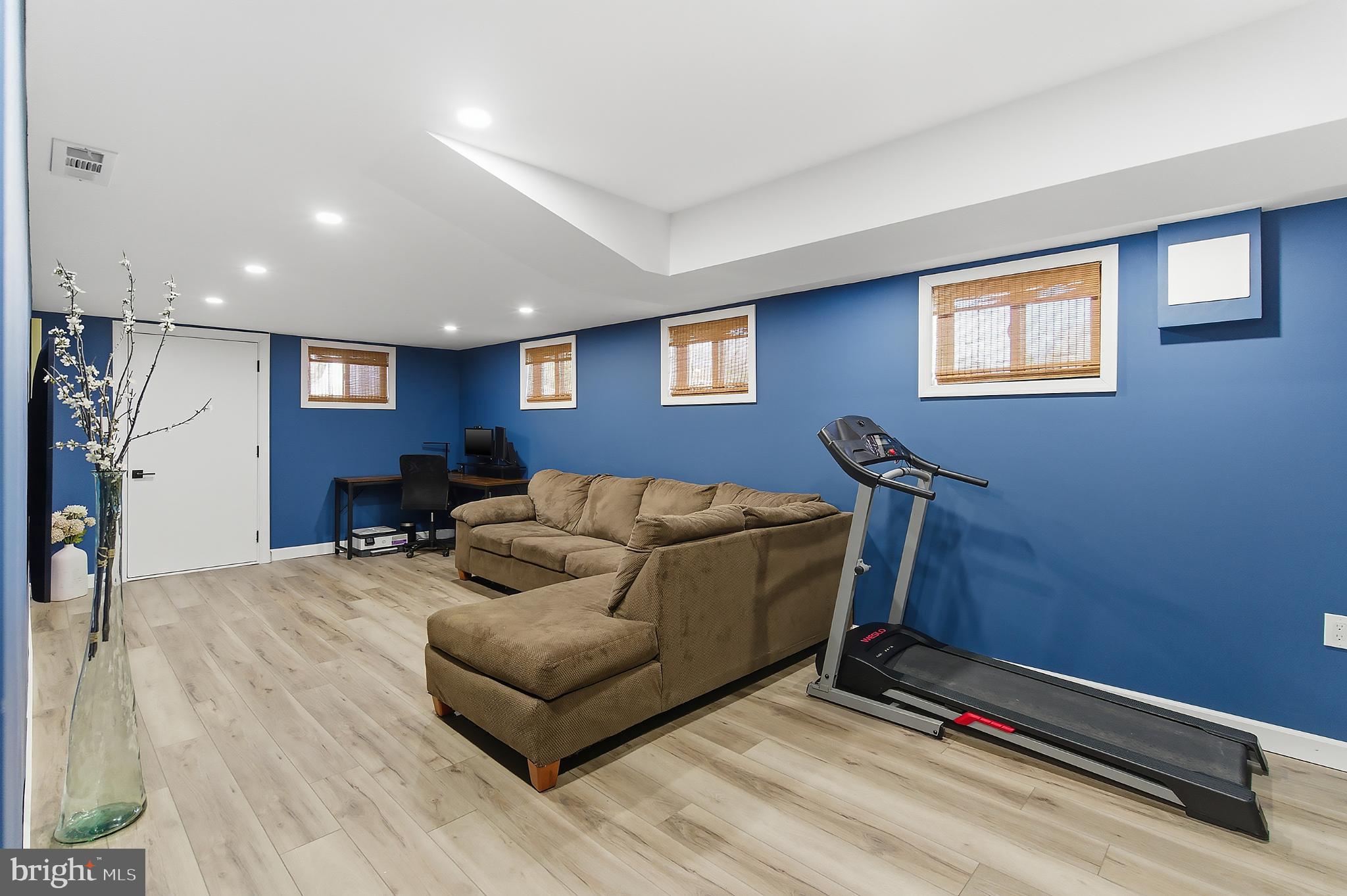 25 Whitman Road Hamilton, NJ 08619 - Photo 23 of 30 Modern basement retreat with vibrant blue walls.