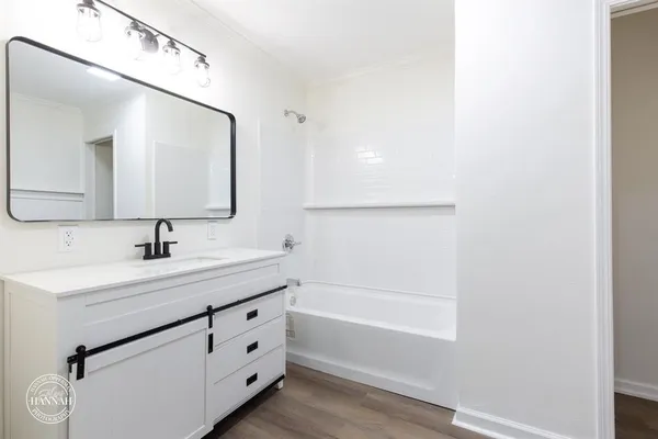 a bathroom with a sink a mirror and a bathtub