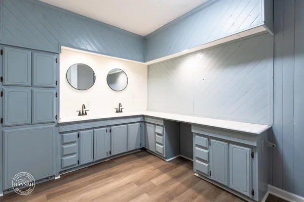 a spacious bathroom with a double vanity sink and a mirror