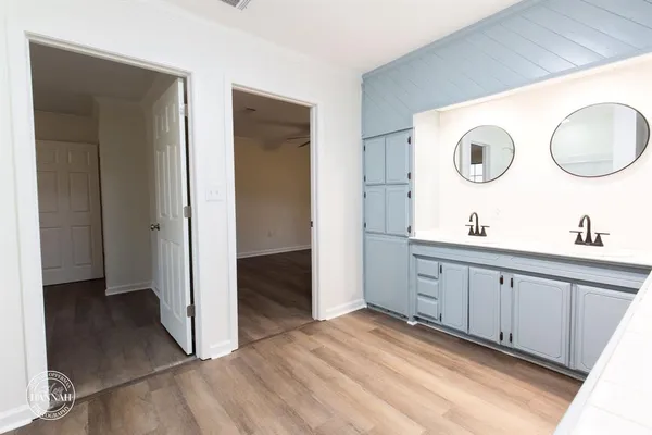 a spacious bathroom with a double vanity sink and a mirror