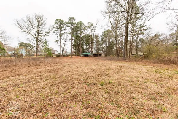 a backyard of a house with large trees