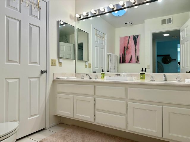 a bathroom with a double vanity sink and a mirror