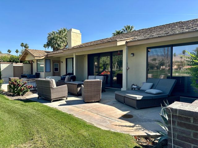 a view of a patio with couches chairs and potted plants