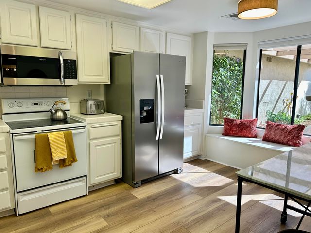 a kitchen with a sink appliances and cabinets