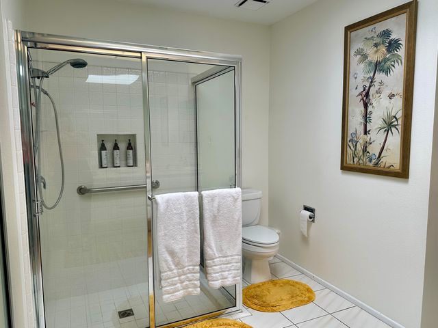 a bathroom with a toilet and a shower