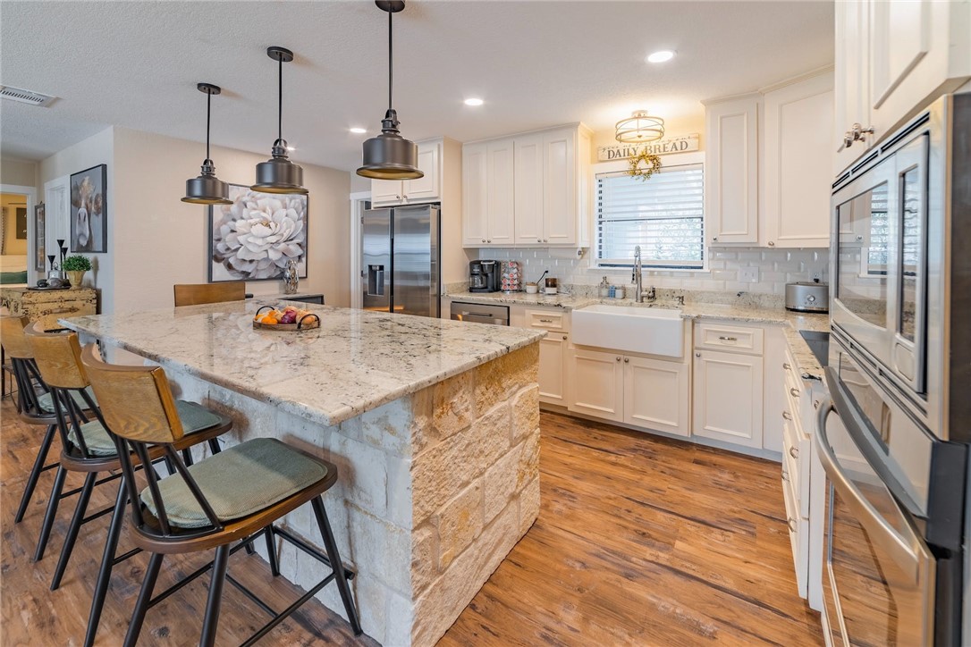 a large kitchen with kitchen island a large island in the center