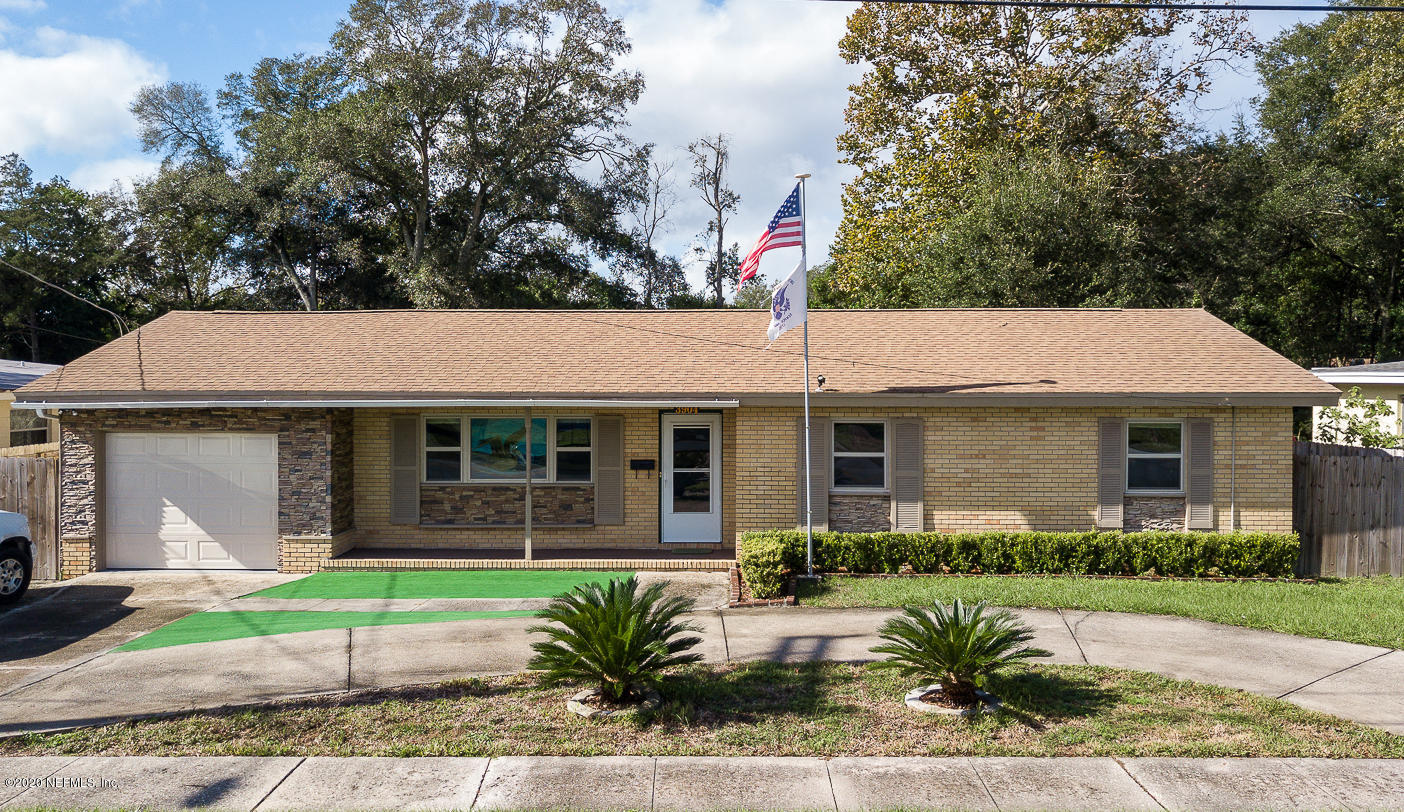 3904 Rogero Road Jacksonville, FL 32277 - Photo 1 of 31 a front view of a house with garden