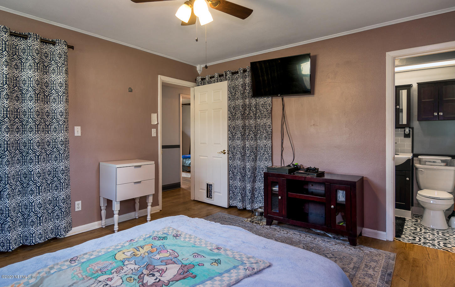 3904 Rogero Road Jacksonville, FL 32277 - Photo 18 of 31 a bedroom with a bed and a flat screen tv