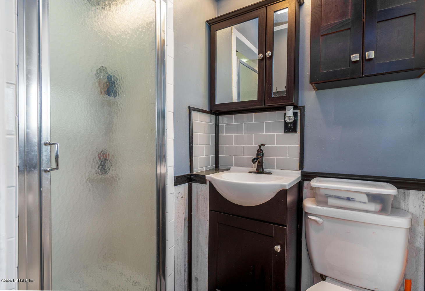 3904 Rogero Road Jacksonville, FL 32277 - Photo 19 of 31 a bathroom with a toilet sink and mirror