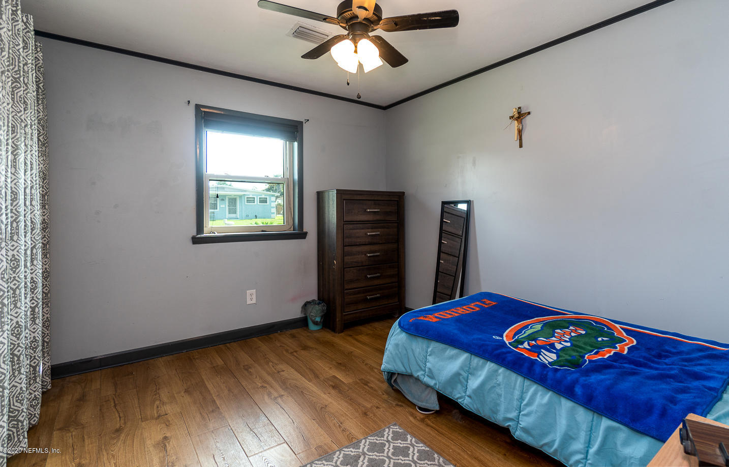 3904 Rogero Road Jacksonville, FL 32277 - Photo 21 of 31 a bedroom with a bed and a wooden floor