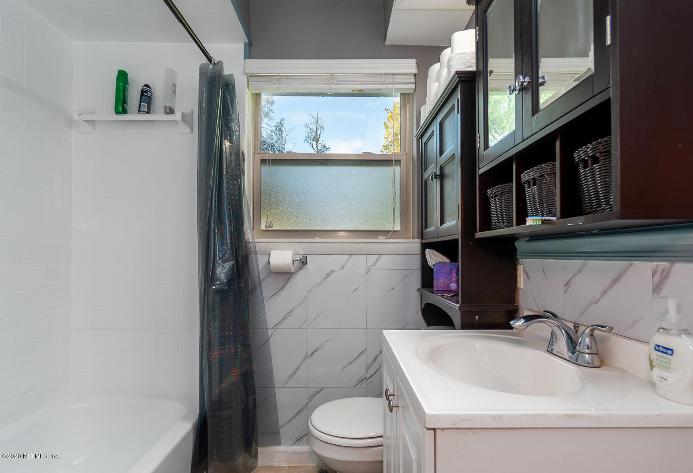 3904 Rogero Road Jacksonville, FL 32277 - Photo 22 of 31 a bathroom with a sink a toilet and a mirror