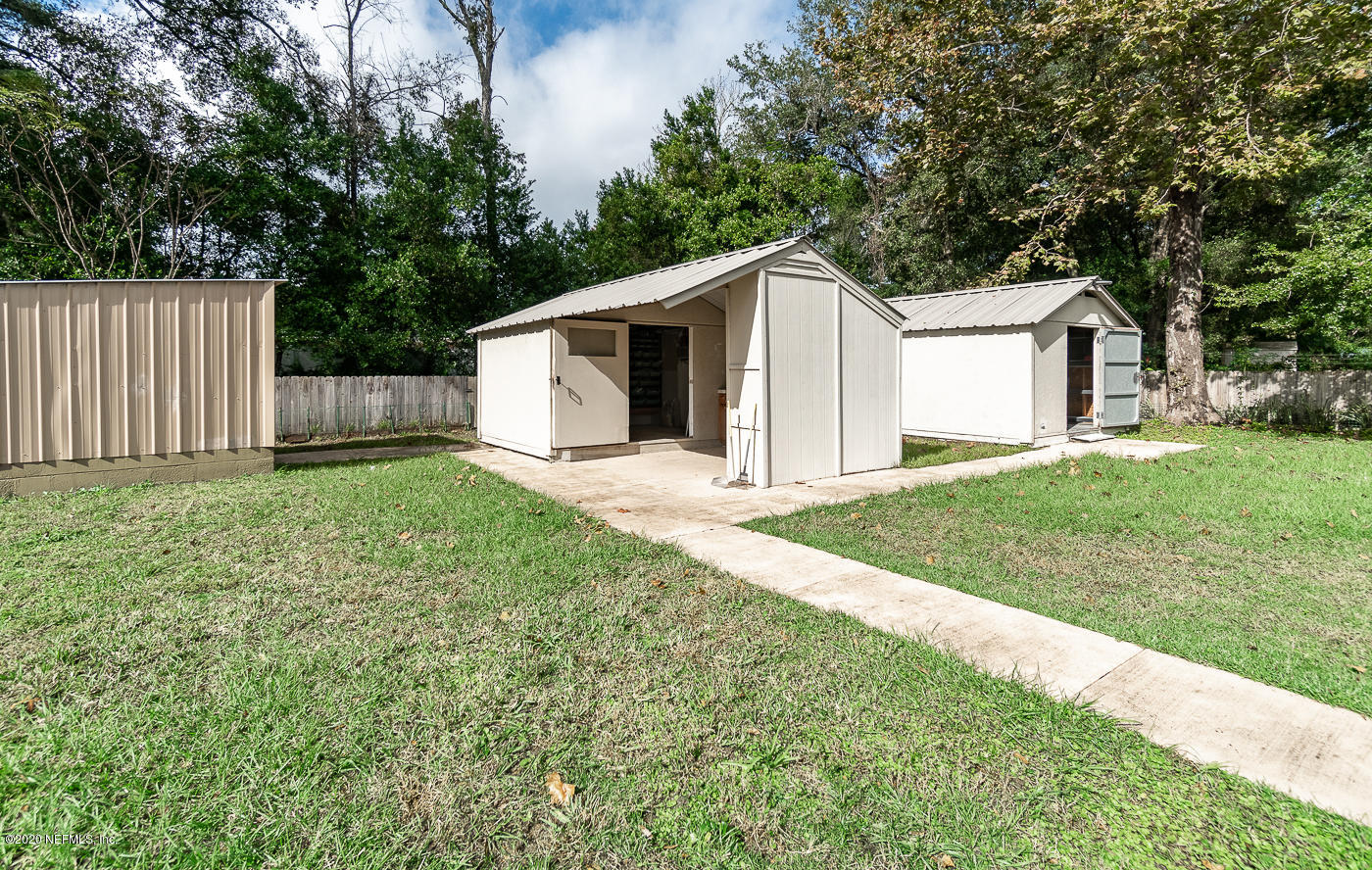 3904 Rogero Road Jacksonville, FL 32277 - Photo 28 of 31 a front view of a house with yard and tree