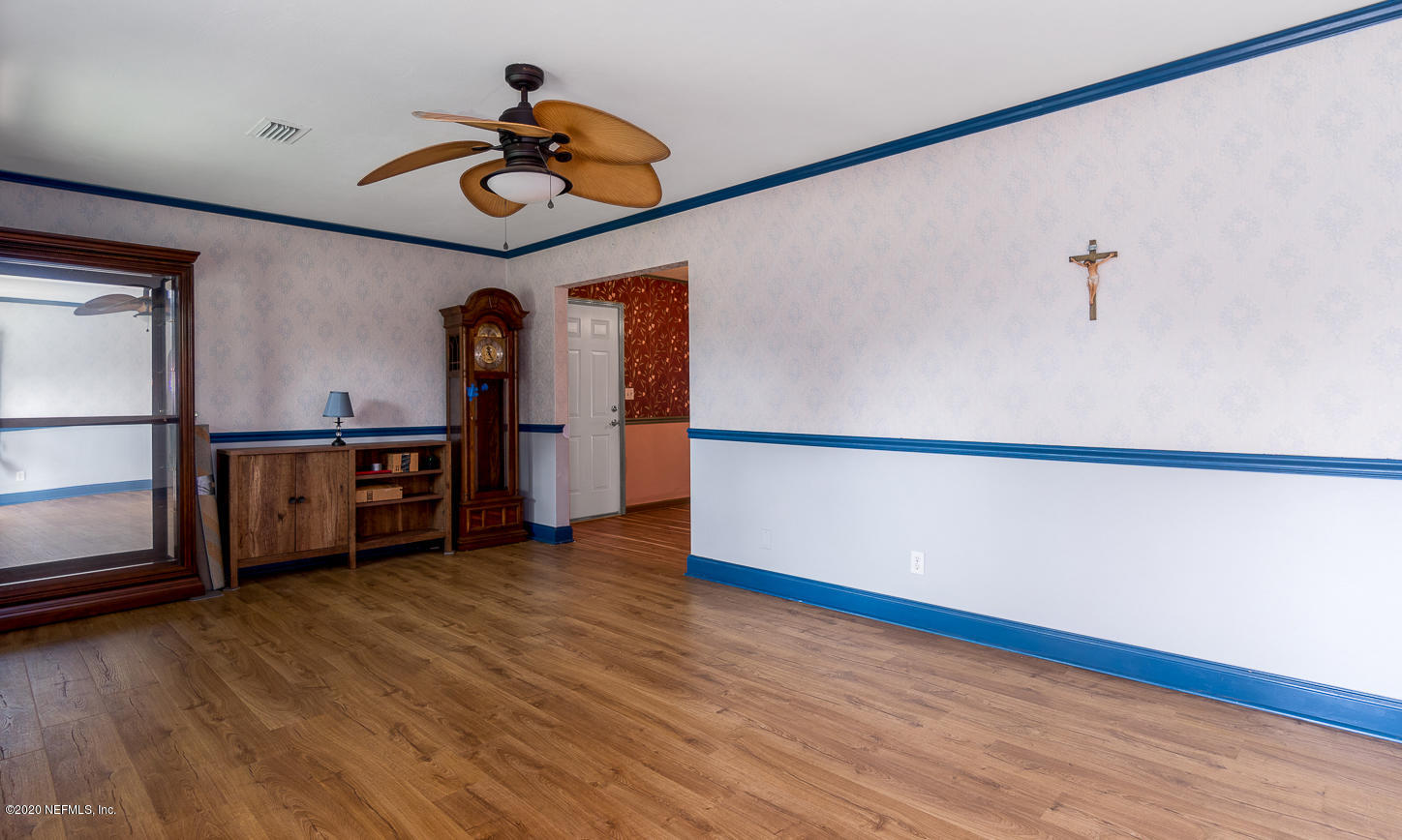 3904 Rogero Road Jacksonville, FL 32277 - Photo 6 of 31 a view of a livingroom with wooden floor and a ceiling fan