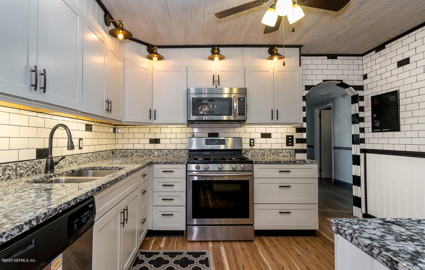 3904 Rogero Road Jacksonville, FL 32277 - Photo 7 of 31 a kitchen with stainless steel appliances granite countertop a stove and a sink