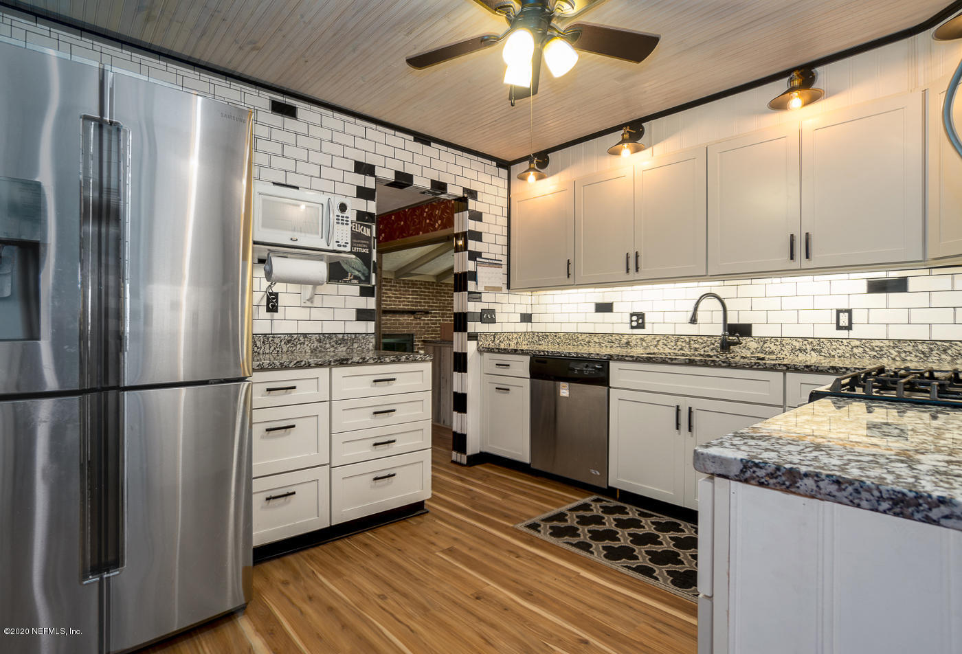 3904 Rogero Road Jacksonville, FL 32277 - Photo 8 of 31 a kitchen with a refrigerator and a sink