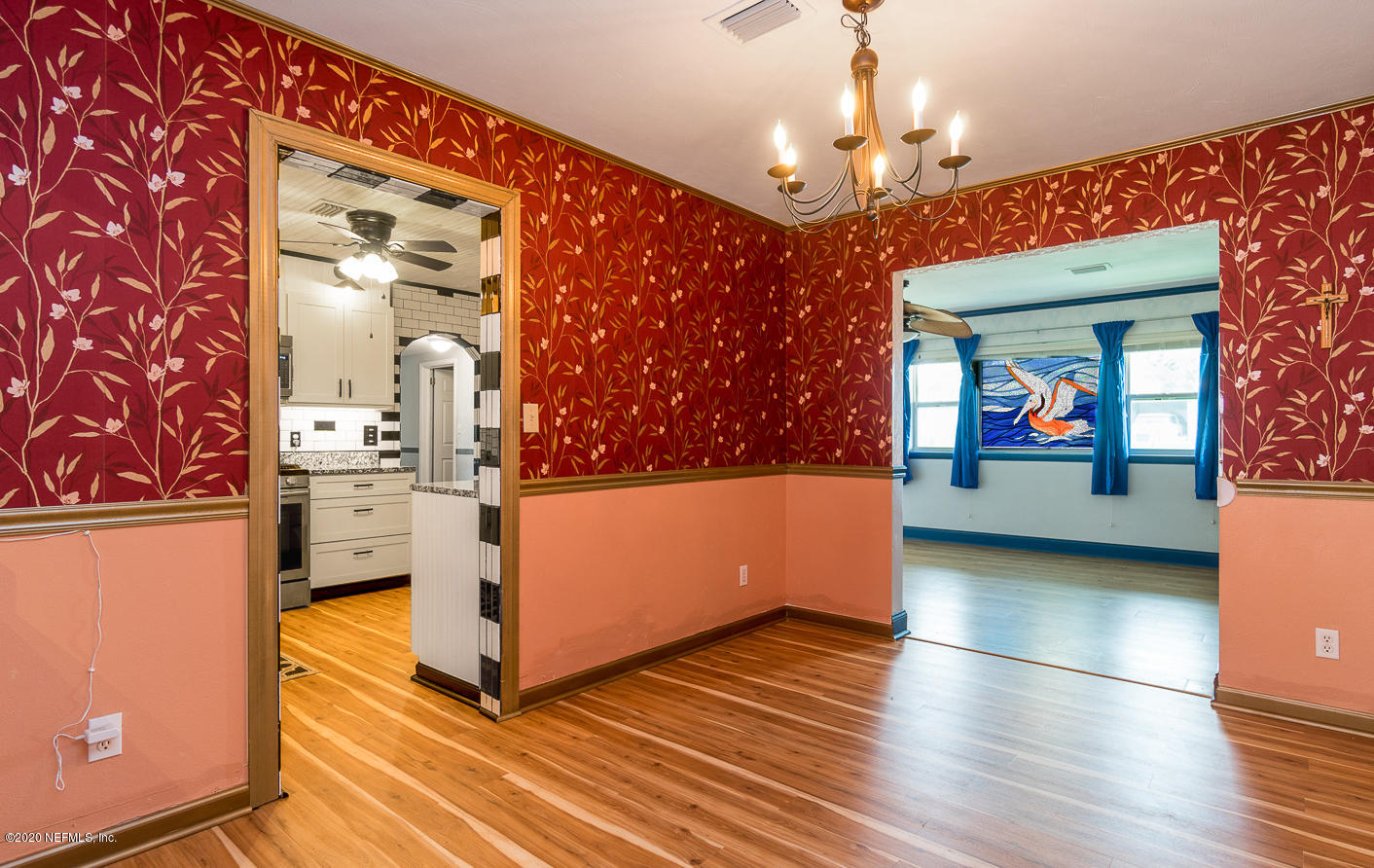 3904 Rogero Road Jacksonville, FL 32277 - Photo 10 of 31 a view of a hallway with dining room and wooden floor