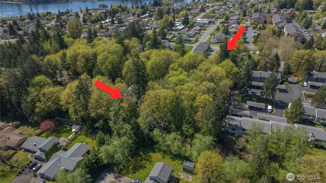 an aerial view of a houses with a yard