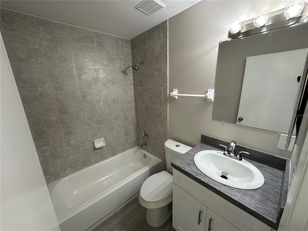 385 Lime Street Maitland, FL 32751 - Photo 8 of 13 a bathroom with a granite countertop sink toilet and shower