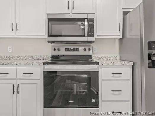 a kitchen with appliances cabinets and a stove top oven