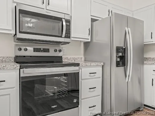 a stove top oven sitting inside of a kitchen