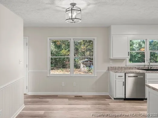 a view of a kitchen with granite countertop cabinets stainless steel appliances and a large window