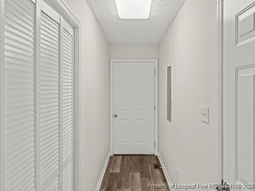 a view of a room with wooden floor and a window