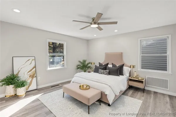 a bedroom with a bed lamp and window