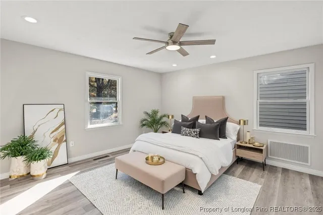 a bedroom with a bed lamp and window