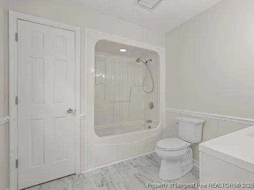 a bathroom with a toilet and shower