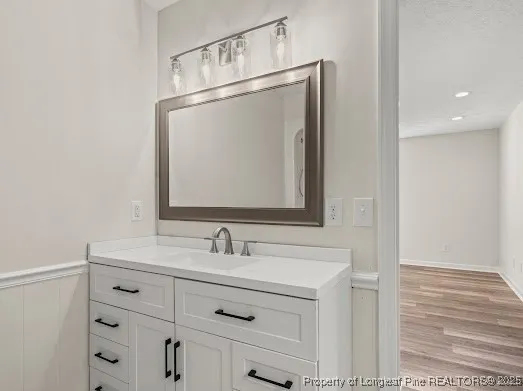 a bathroom with a sink vanity and a mirror