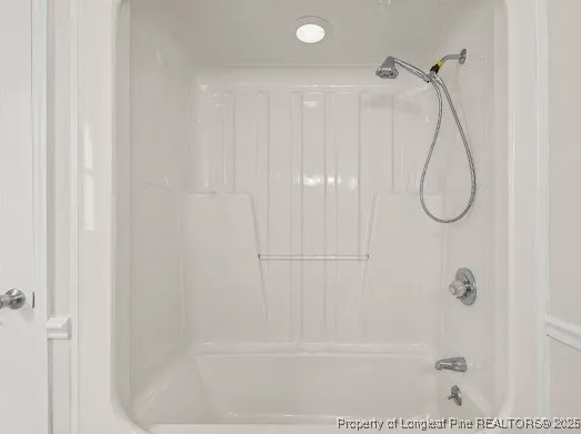 a bathroom with a glass shower door