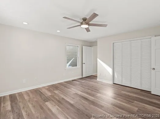 a view of a livingroom with a ceiling fan and wooden floor