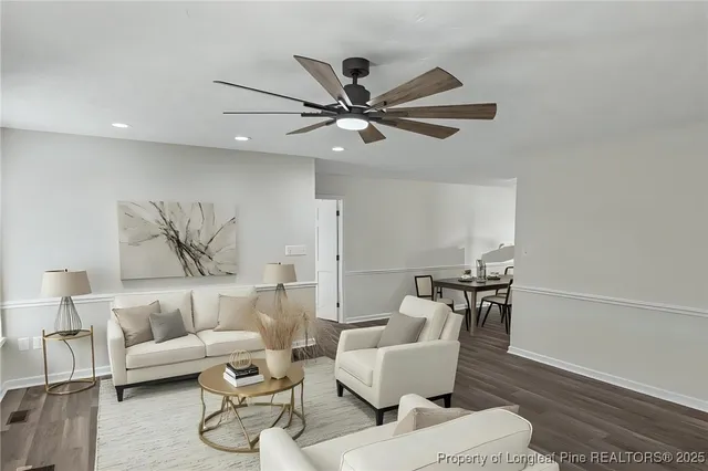 a living room with furniture and a ceiling fan