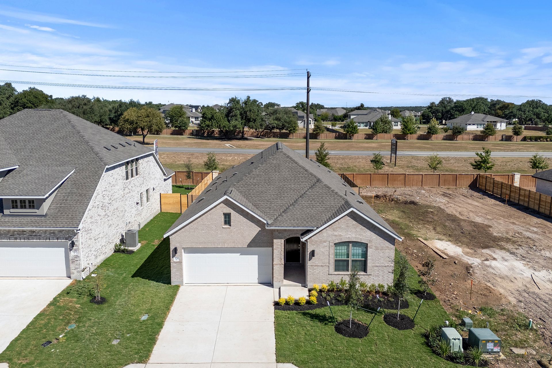 336 Ridgewell Loop Georgetown, TX 78633 - Photo 23 of 31 a view of a house with a yard and potted plants