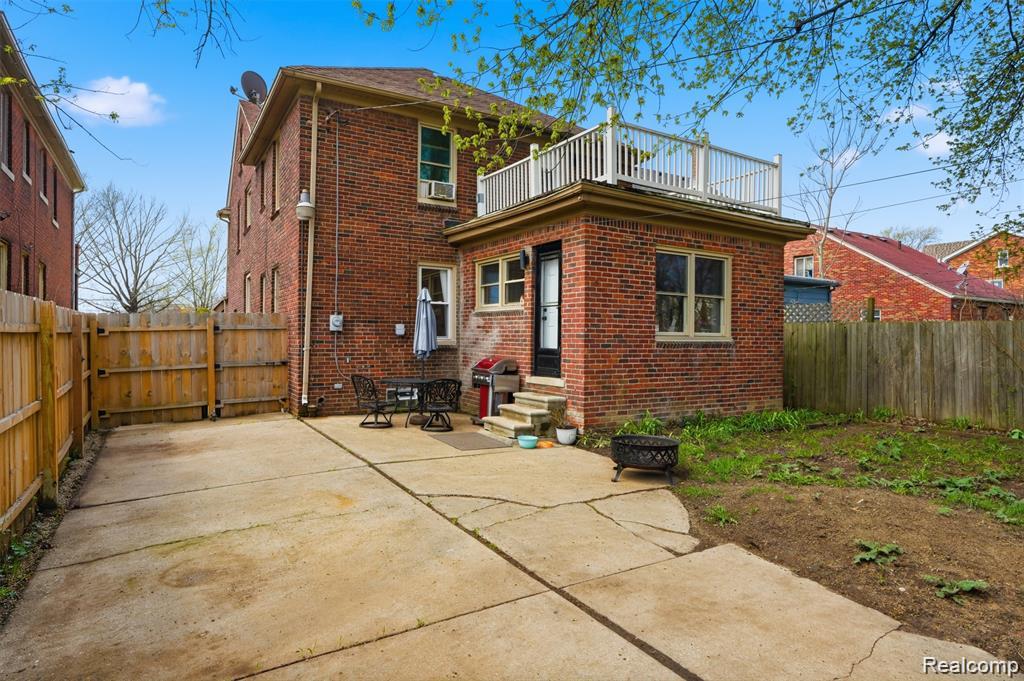 4612 Balfour Road Detroit, MI 48224 - Photo 19 of 20 Brick exterior featuring a second-story balcony with white railing