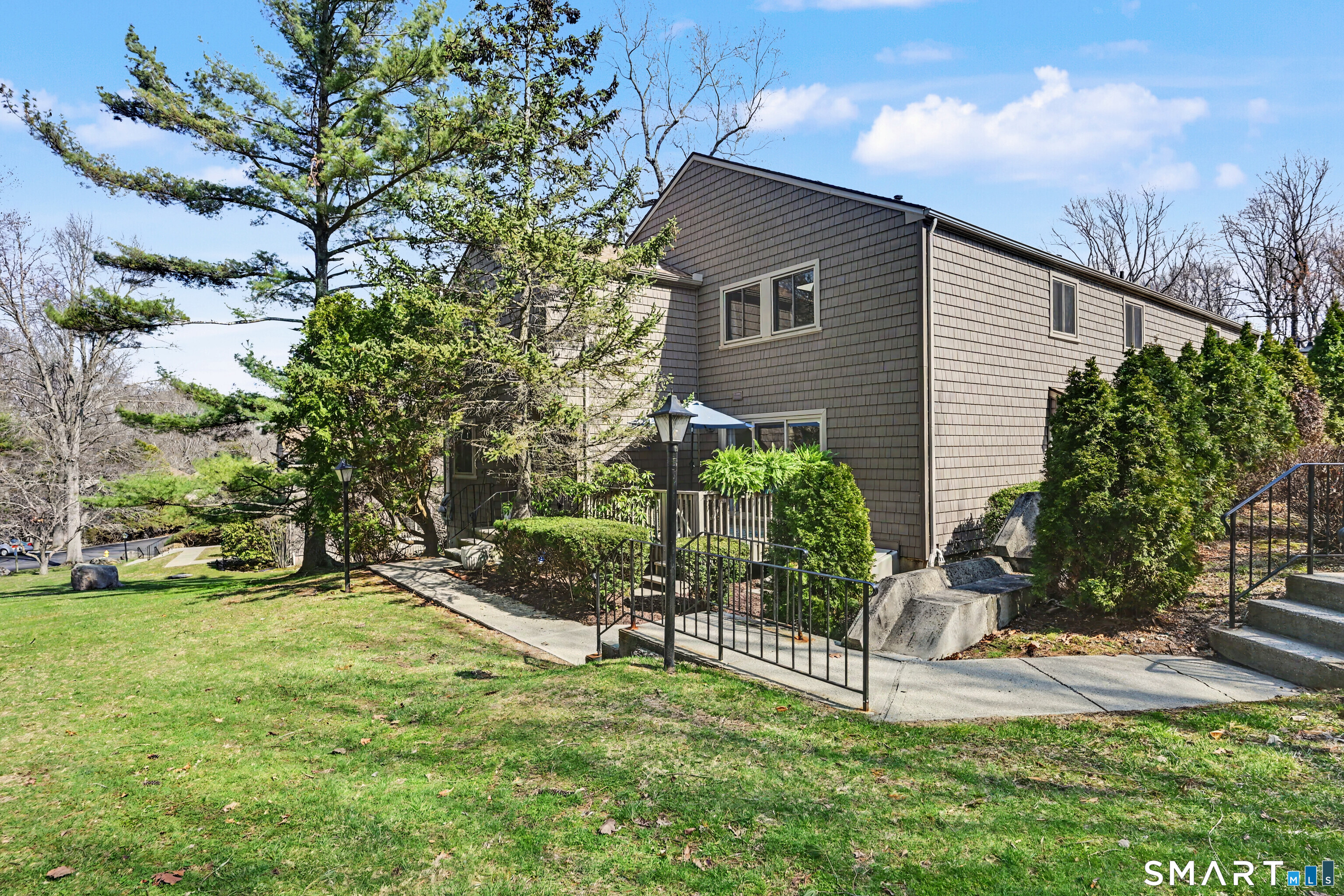 42 Powder Mill Road, Unit B Stratford, CT 06614 - Photo 33 of 40 View of community grounds looking toward the sun porch