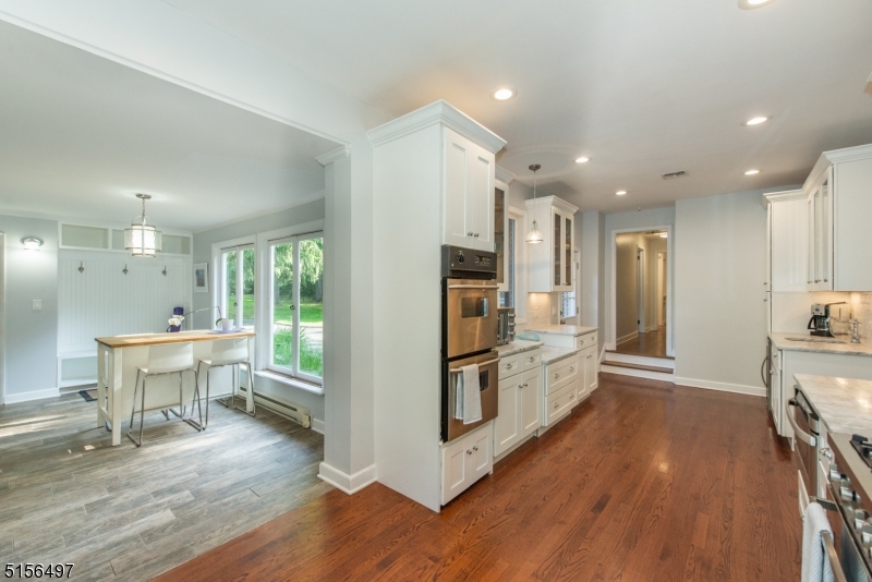 32 Parsonage Hill Road Short Hills, NJ 07078 - Photo 18 of 47 a kitchen with kitchen island wooden floors appliances and cabinets